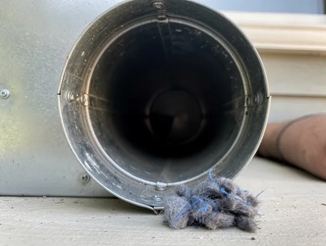 Palm Harbor Dryer Vent Cleaning technician using specialized equipment to clear severe dryer vent blockage in Palm Harbor